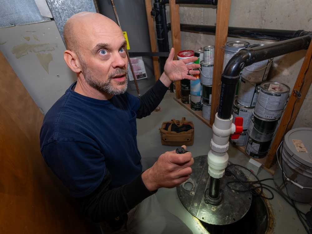 man looking at sump pump